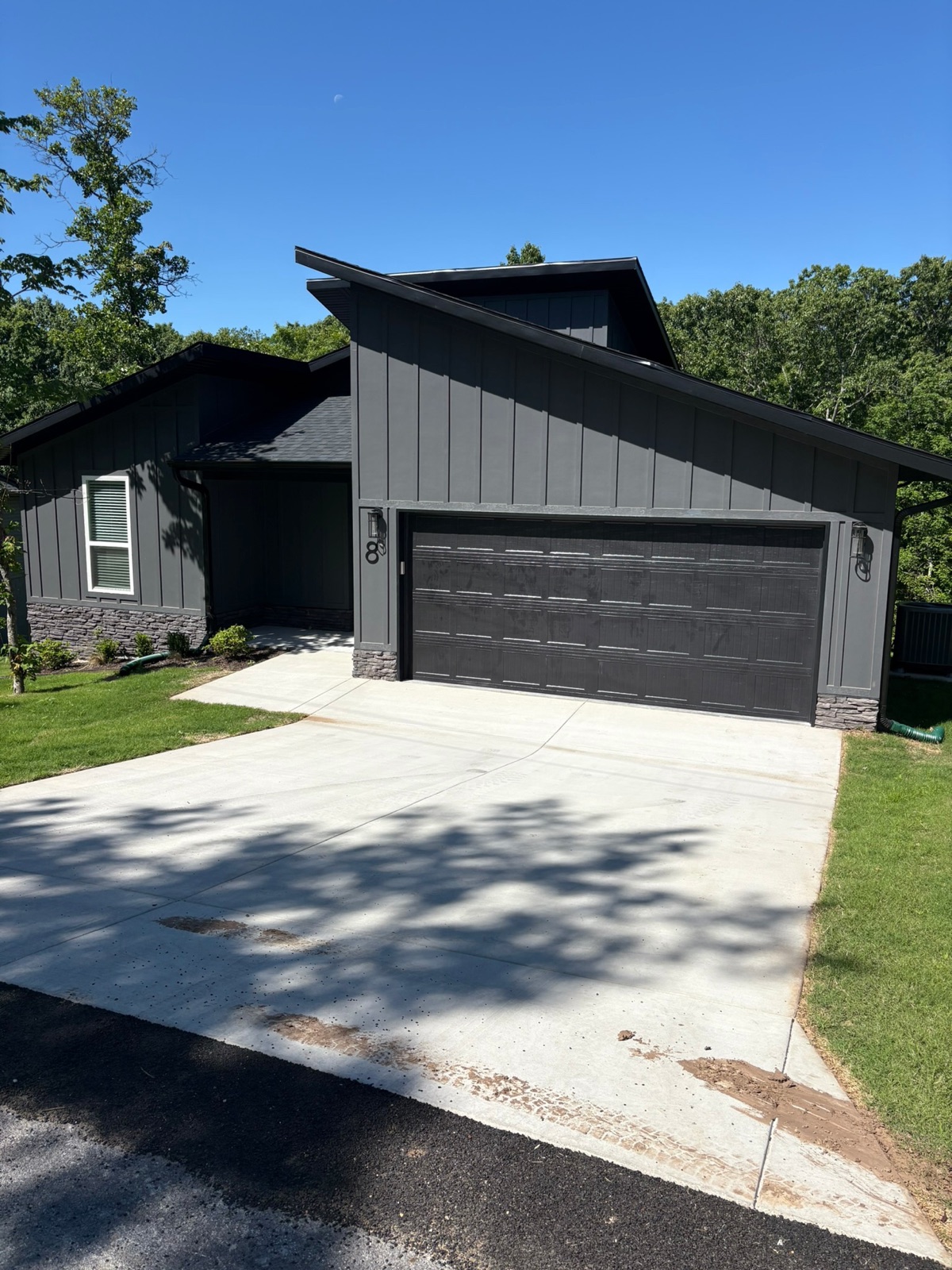 Finished new-construction home with a freshly cleaned driveway