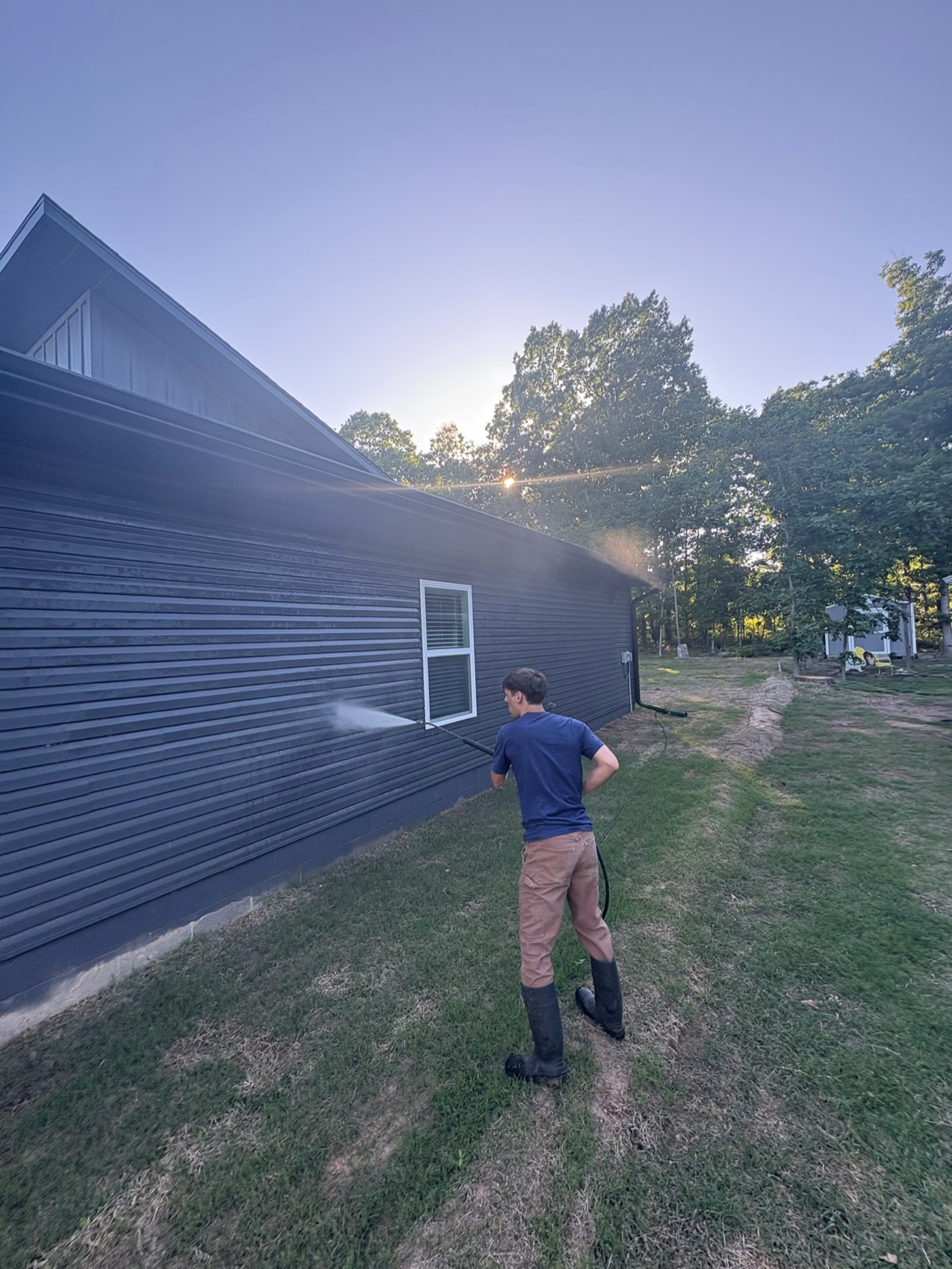Iron Jet soft-washing the exterior of a newly built home
